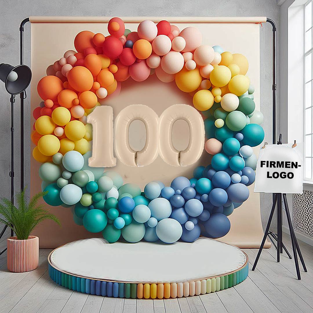 Ein farbenfroher Ballonkreis in Regenbogenfarben für eine Feier zum 100-jährigen Firmenjubiläum.